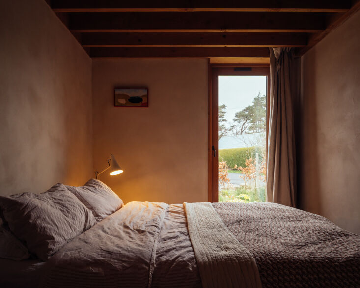 a glass door to the bedroom serves as light source, with curtains that hang on  29