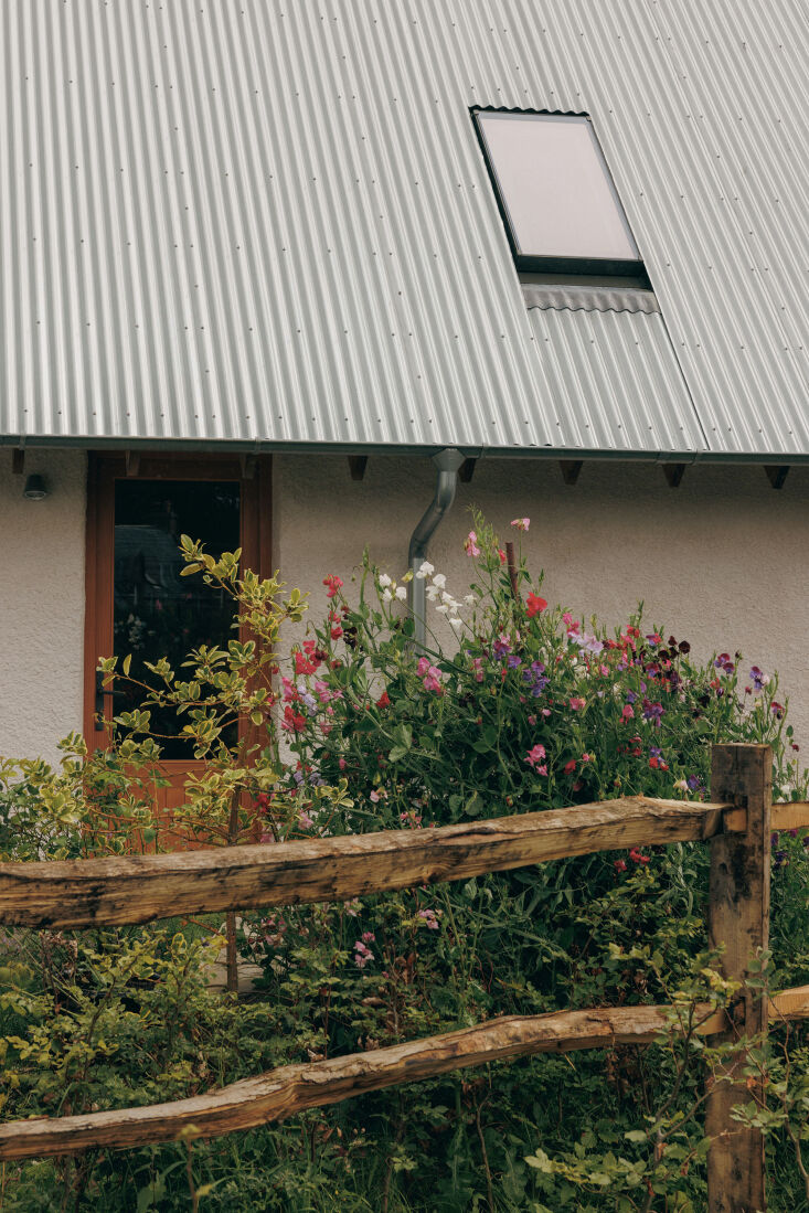 detail of the aluminum clad roof and drain pipes; an entry door is made of doug 21