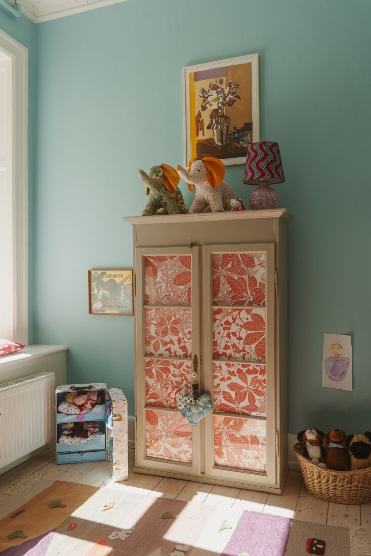 the two girls share a bedroom overlooking the garden. the display cabinet is a 31