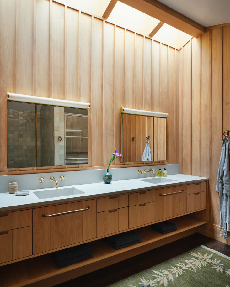 as with much of the other hardware throughout the house, the bronze towel rods 32