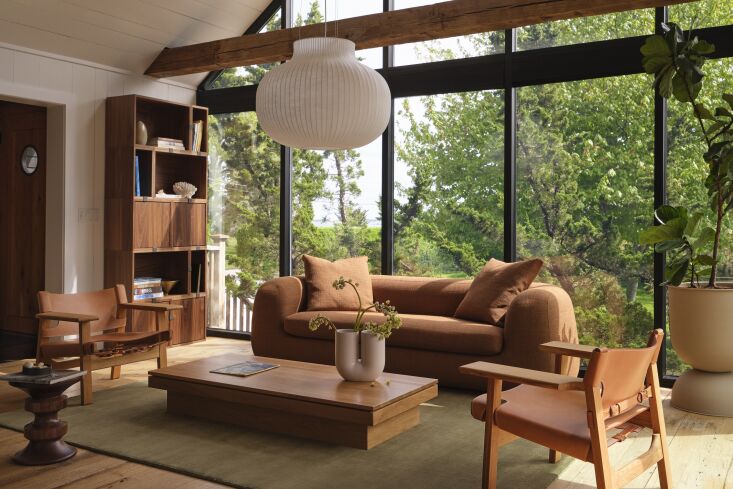 floor to ceiling glass walls are on either end of the house. the living room is 20