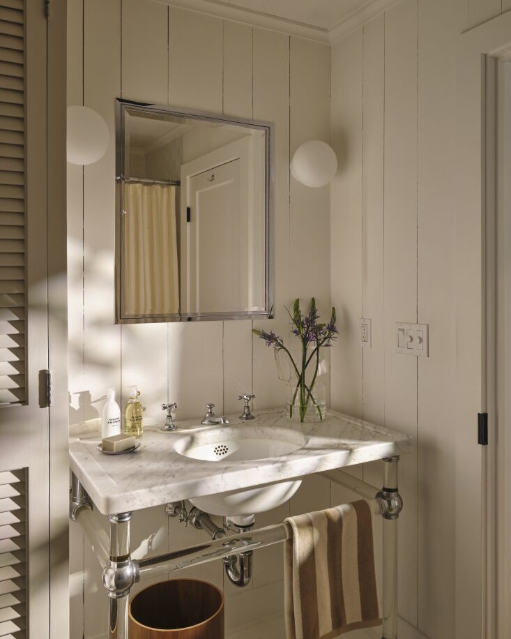 a traditional marble sink and shiplap in another bathroom. 28