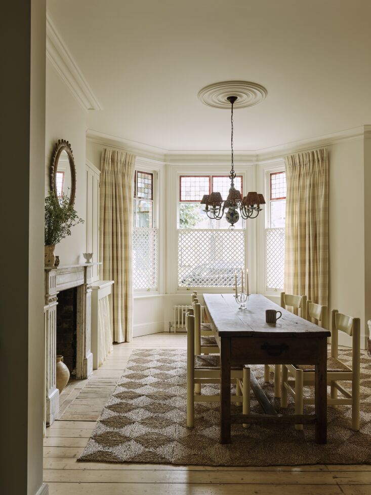the dining room is designed with a chandelier sourced on ebay for the clients&a 25