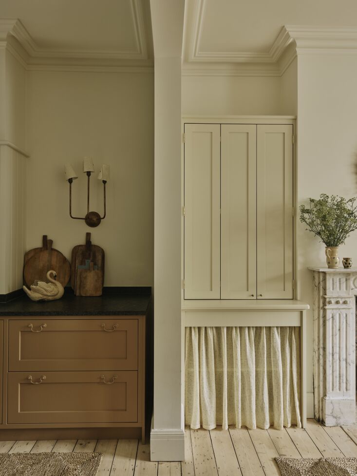 the built in cabinet to the right functions as a hidden bar with the curtained 24