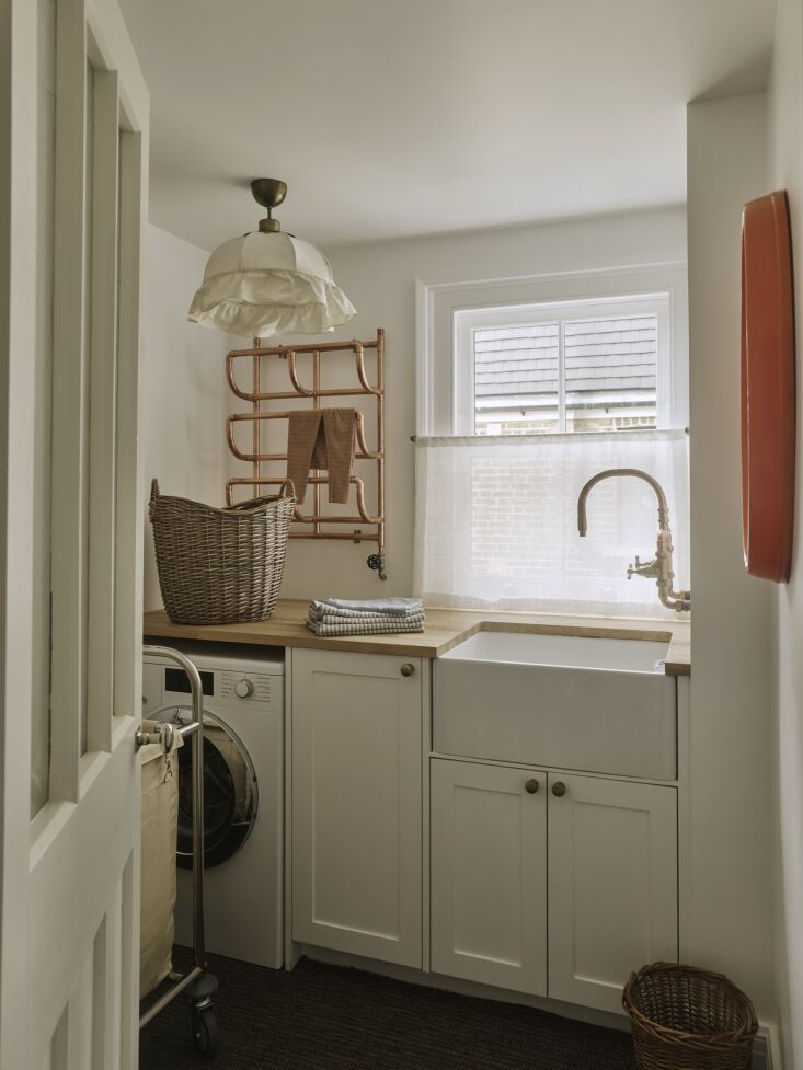 a josef frank pendant lamp in the laundry room which is fitted with a custom br 42
