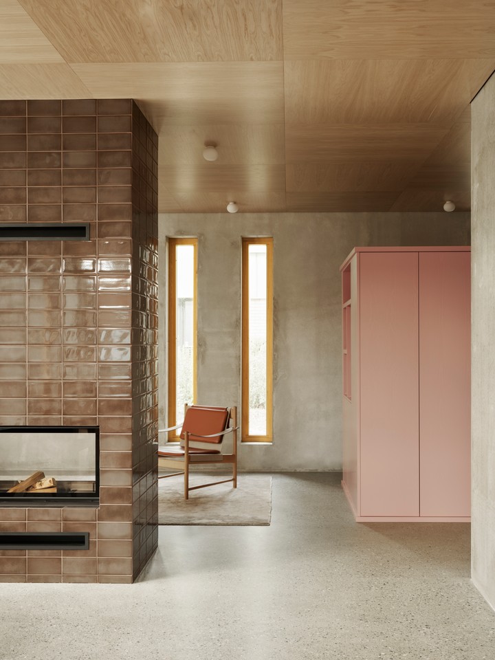a look into the living area, with a pink painted storage unit/room divider/ward 24