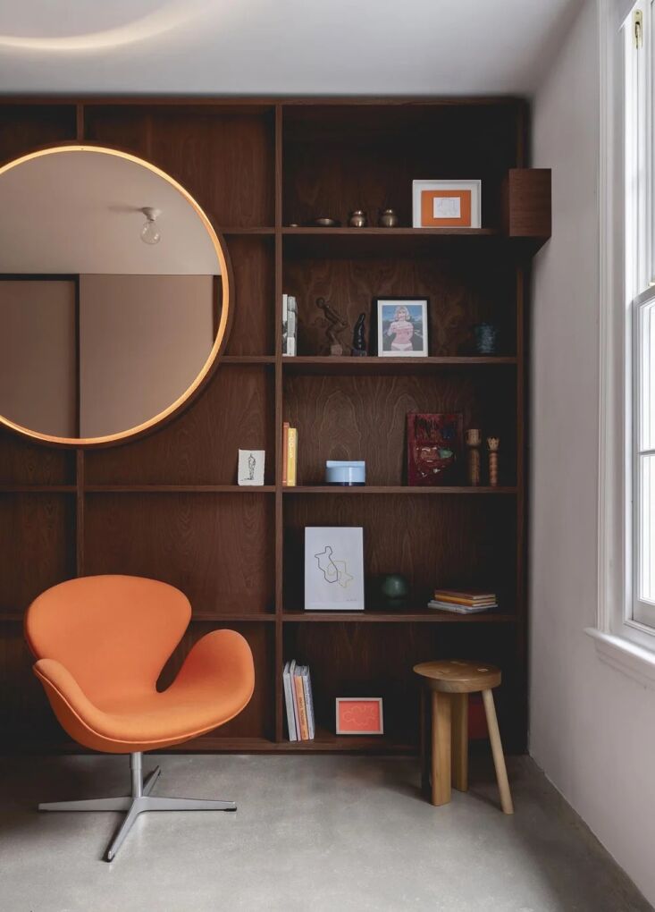 an arne jacobsen swan chair in orange and the face stool by studiomama. 30
