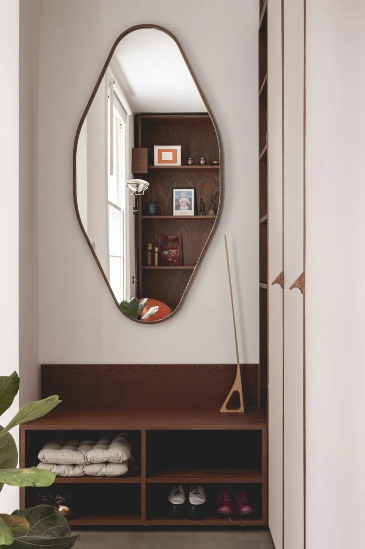 entryway storage and a custom sculptural mirror. 32
