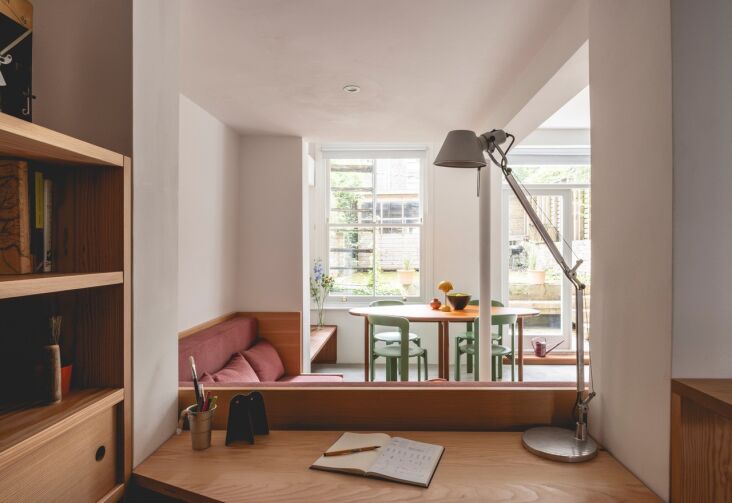 a compact office overlooks the living room just behind the sofa. a tolomeo desk 23