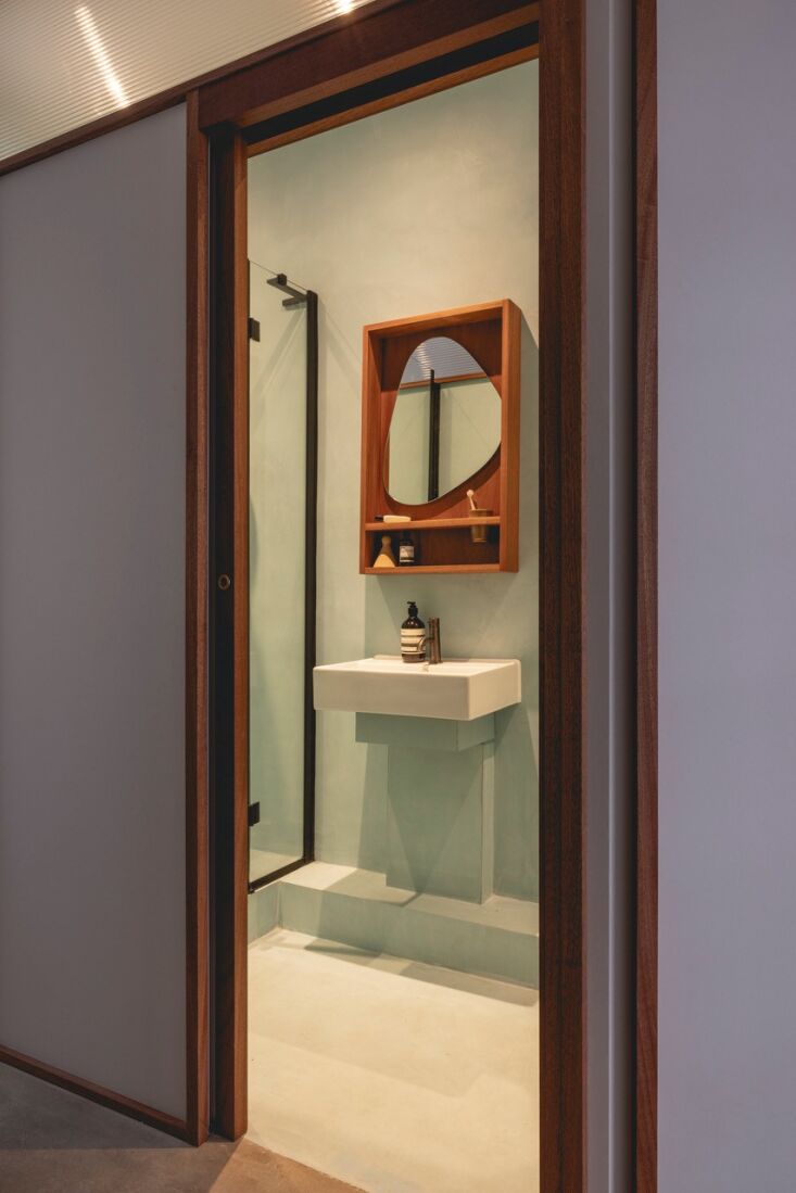 the mint theme continues into a hidden compact bath. 26