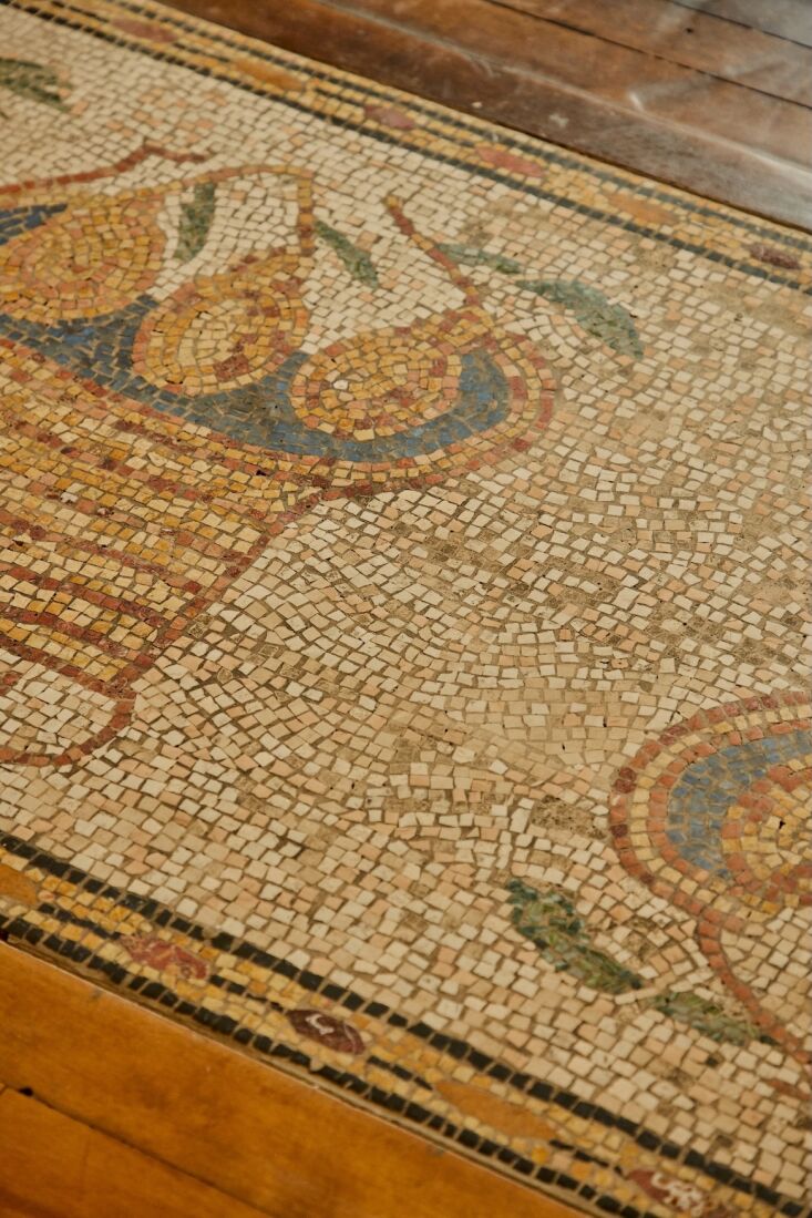 the roman antiquity inspired mosaic in the entry is the work of m.c. mosaics an 18