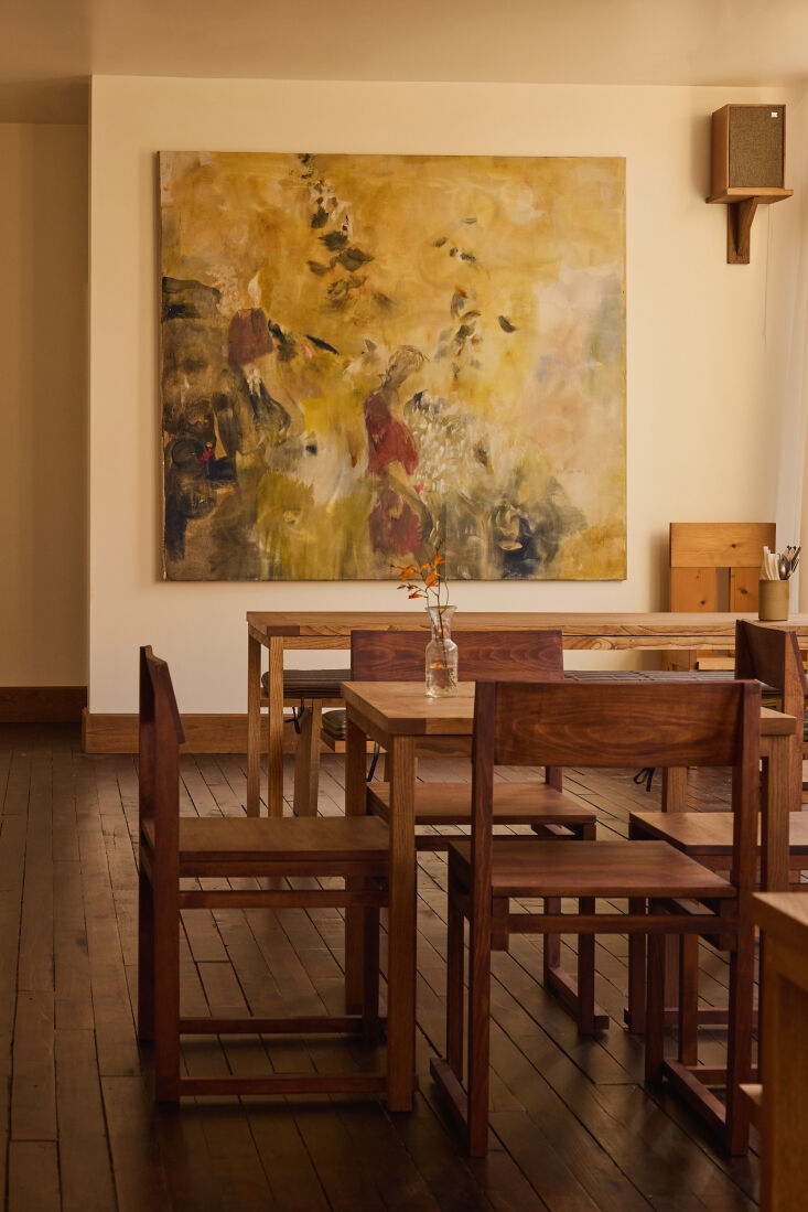 anchoring the dining area is a painting by nick jensen whose work has been desc 24