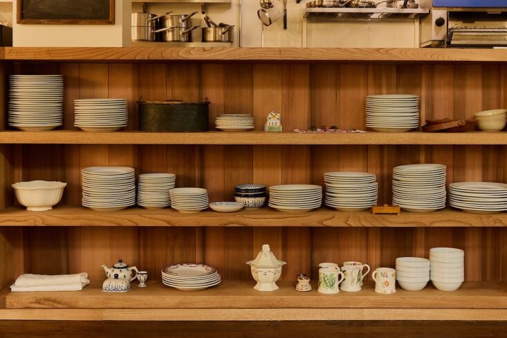 behind the shelves is an open kitchen. 27