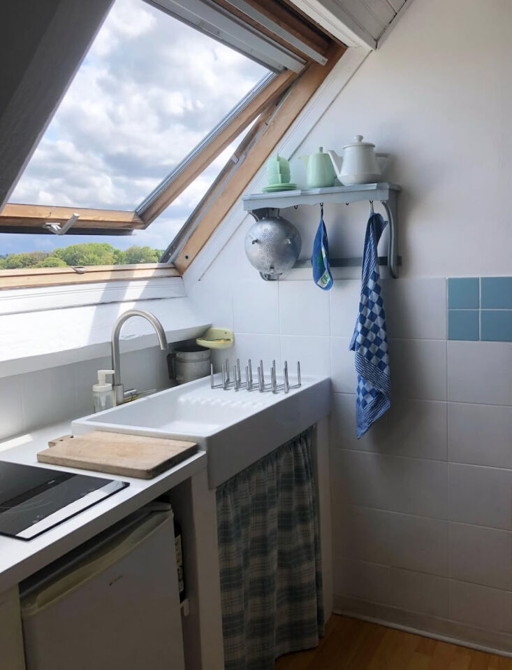 a kitchen under the eaves with a rooftop casement window that opens to the sky. 29