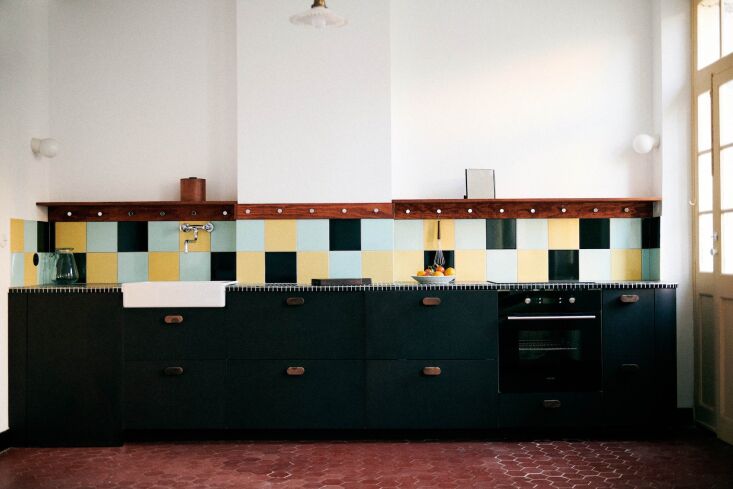 in another kitchen in the building, a fresh approach using the same materials.  23